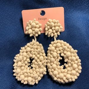 White beaded dangle earrings.